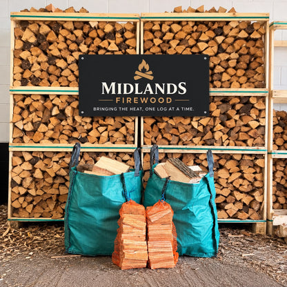 Two green barrow bags of kiln-dried firewood with two kindling packs at Midlands Firewood
