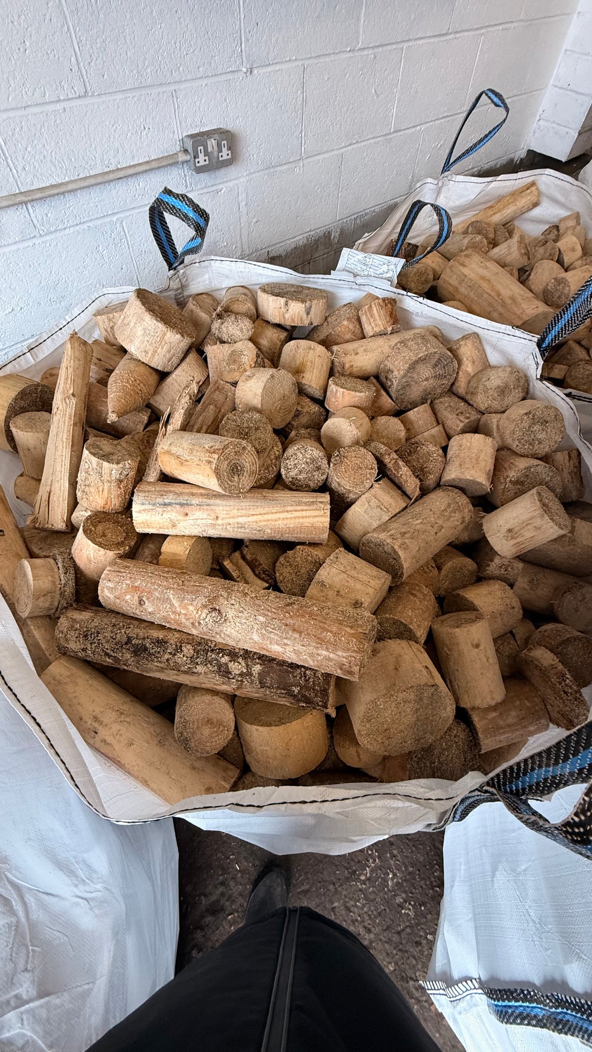 Bulk bags filled with mixed-size wonky firewood offcuts